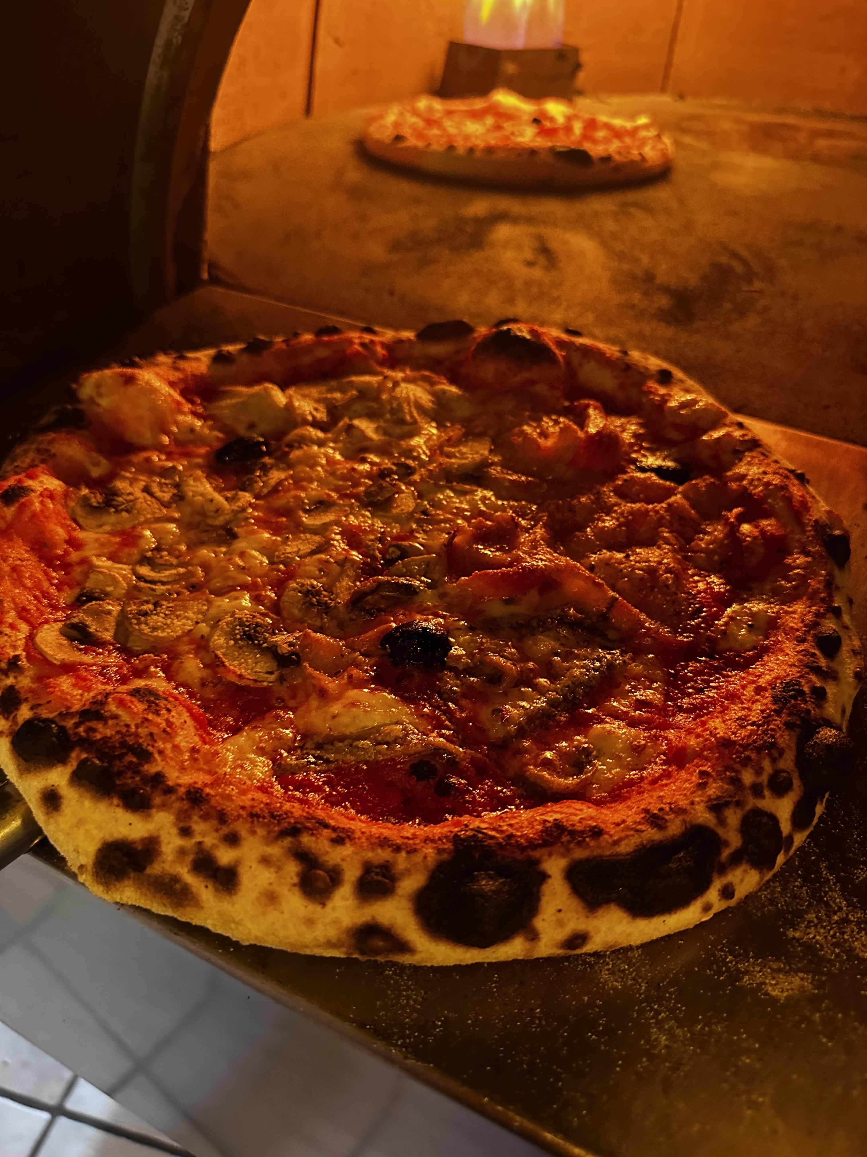 Pizza champignons jambon devant le four